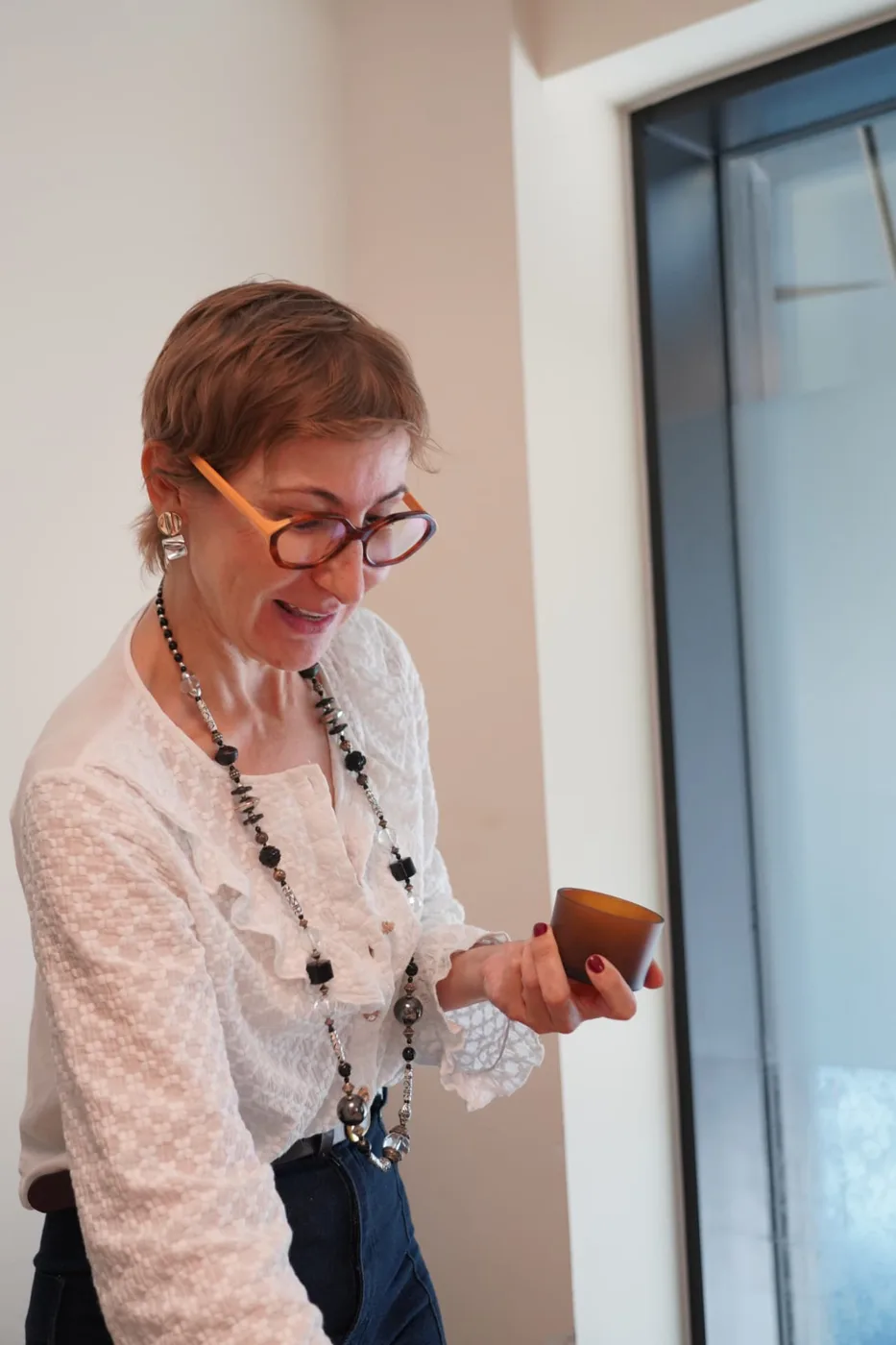 The Lumara Botanic founder holding a candle vessel at a workshop