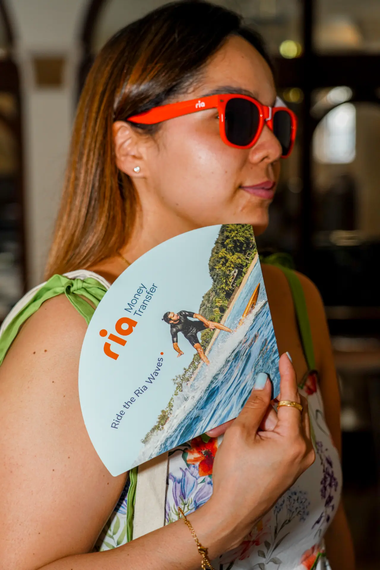 Guest holding branded partner merchandise at a campaign event