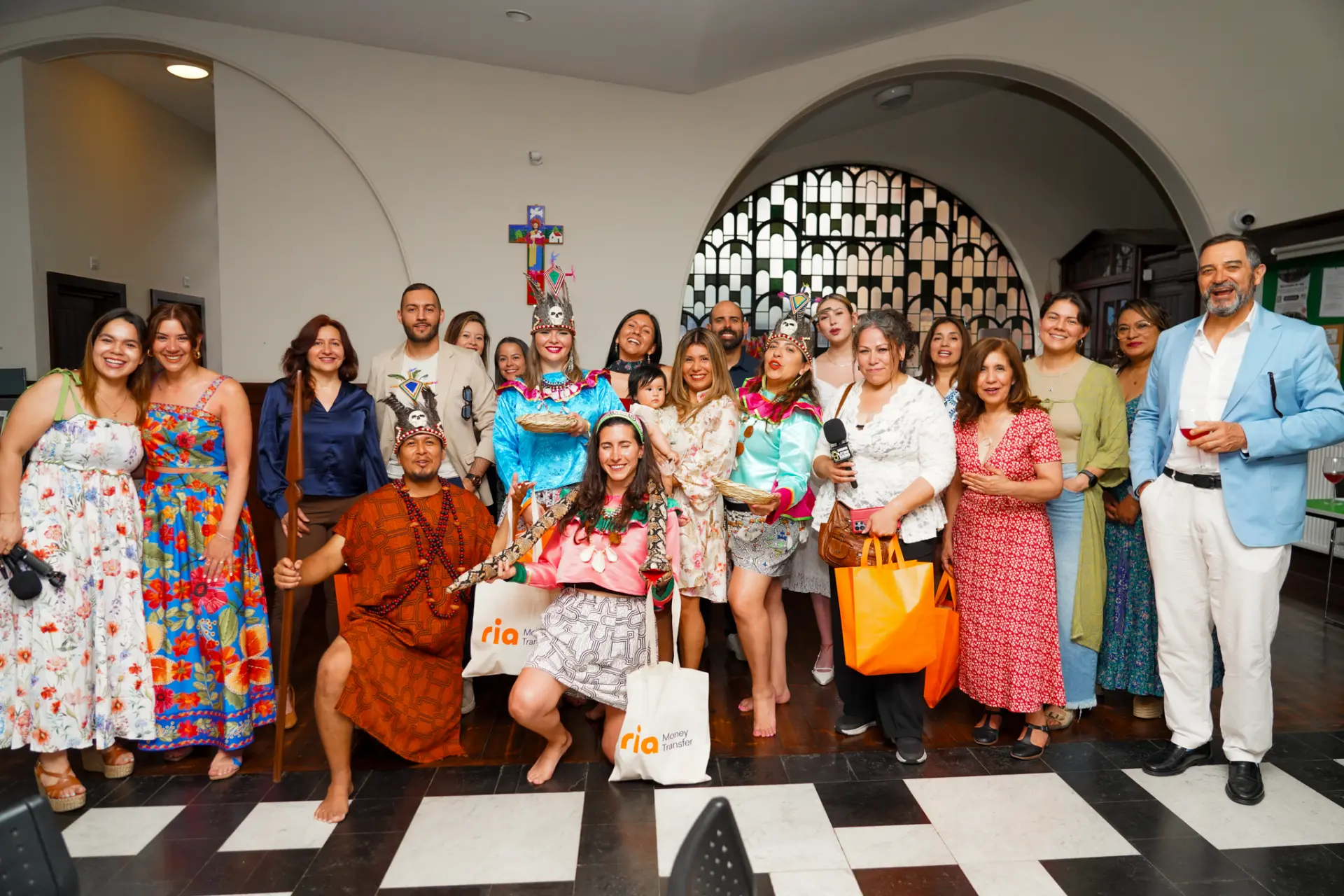 Large group portrait at the launch event with performers in traditional Latin American dress