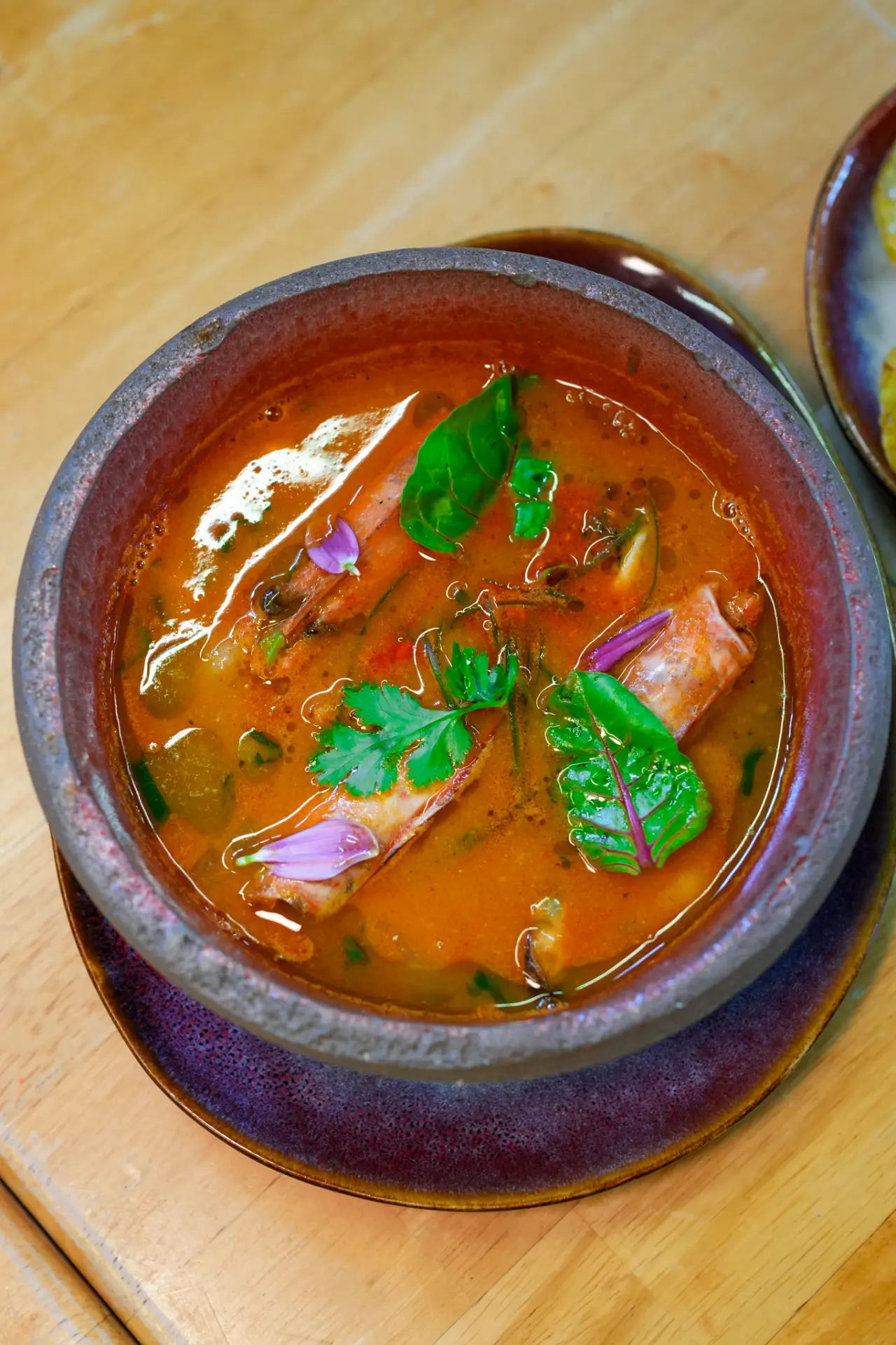 Soup served in a glazed ceramic bowl at Tacacho Van Gogh