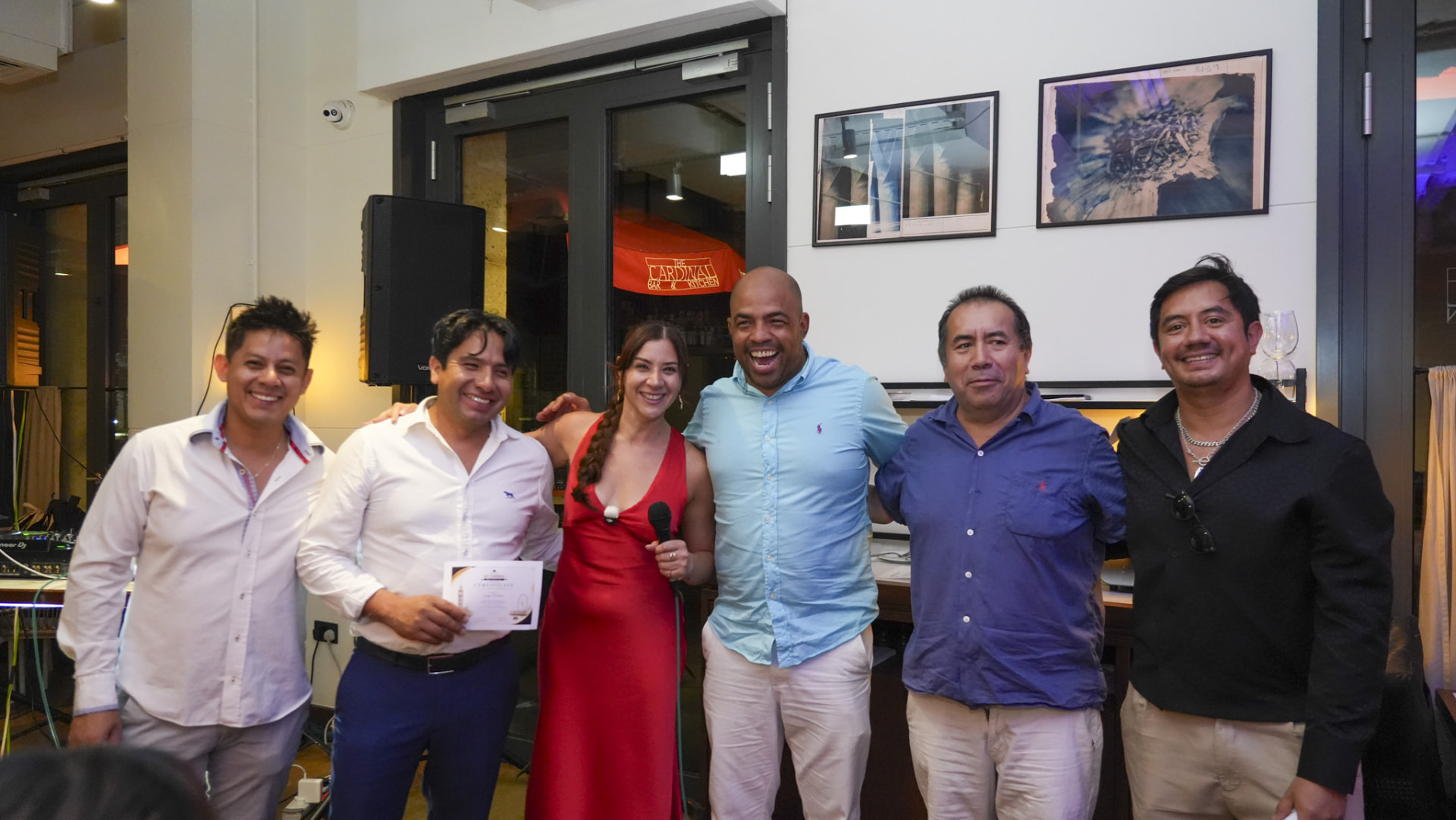 Host and judges presenting a certificate at a campaign event