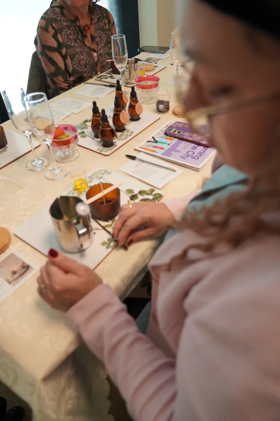 A workshop table set with fragrance oils and materials