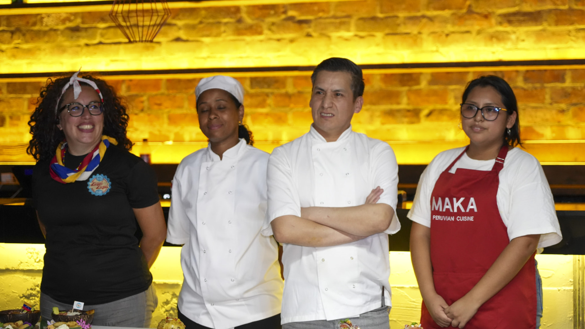 Four chefs standing behind their dishes during the Grand Final cook-off